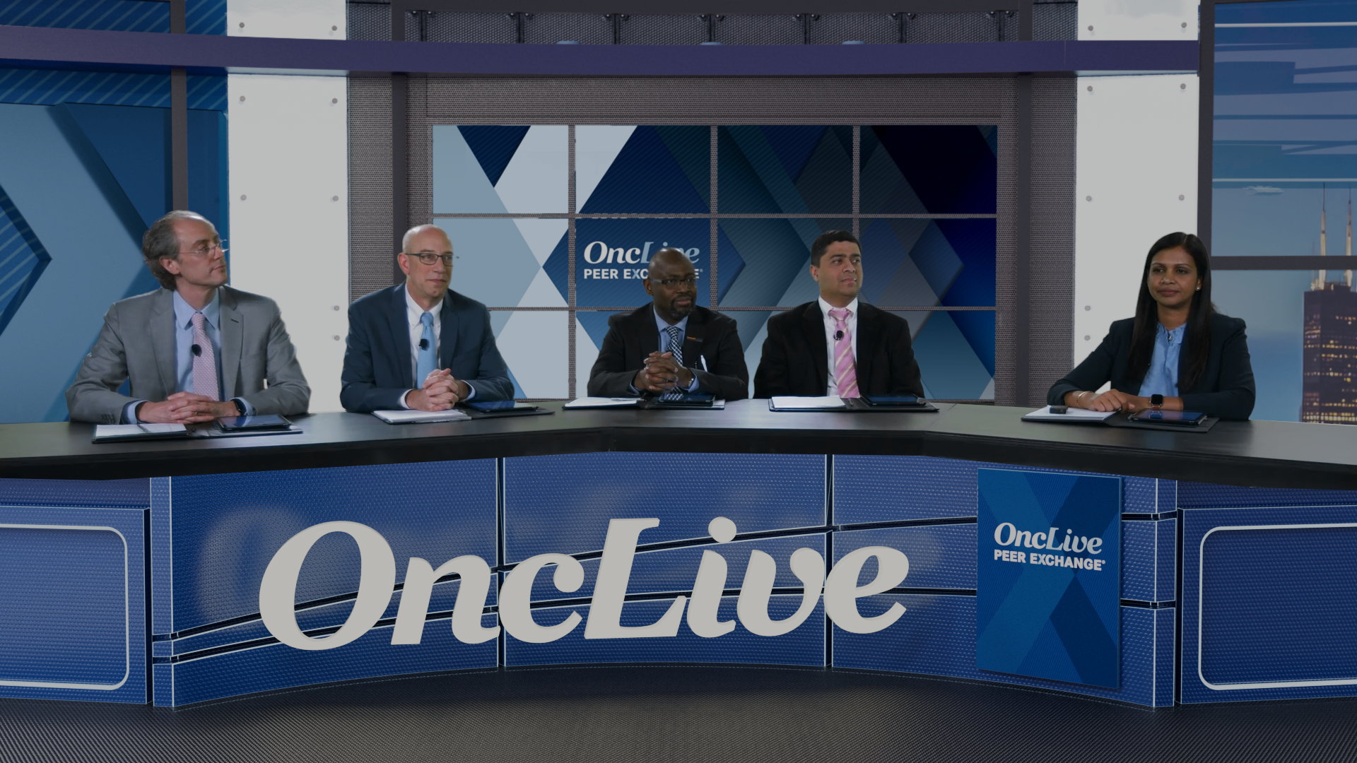 a panel of experts in small cell lung cancer, sitting behind a table with the OncLive logo