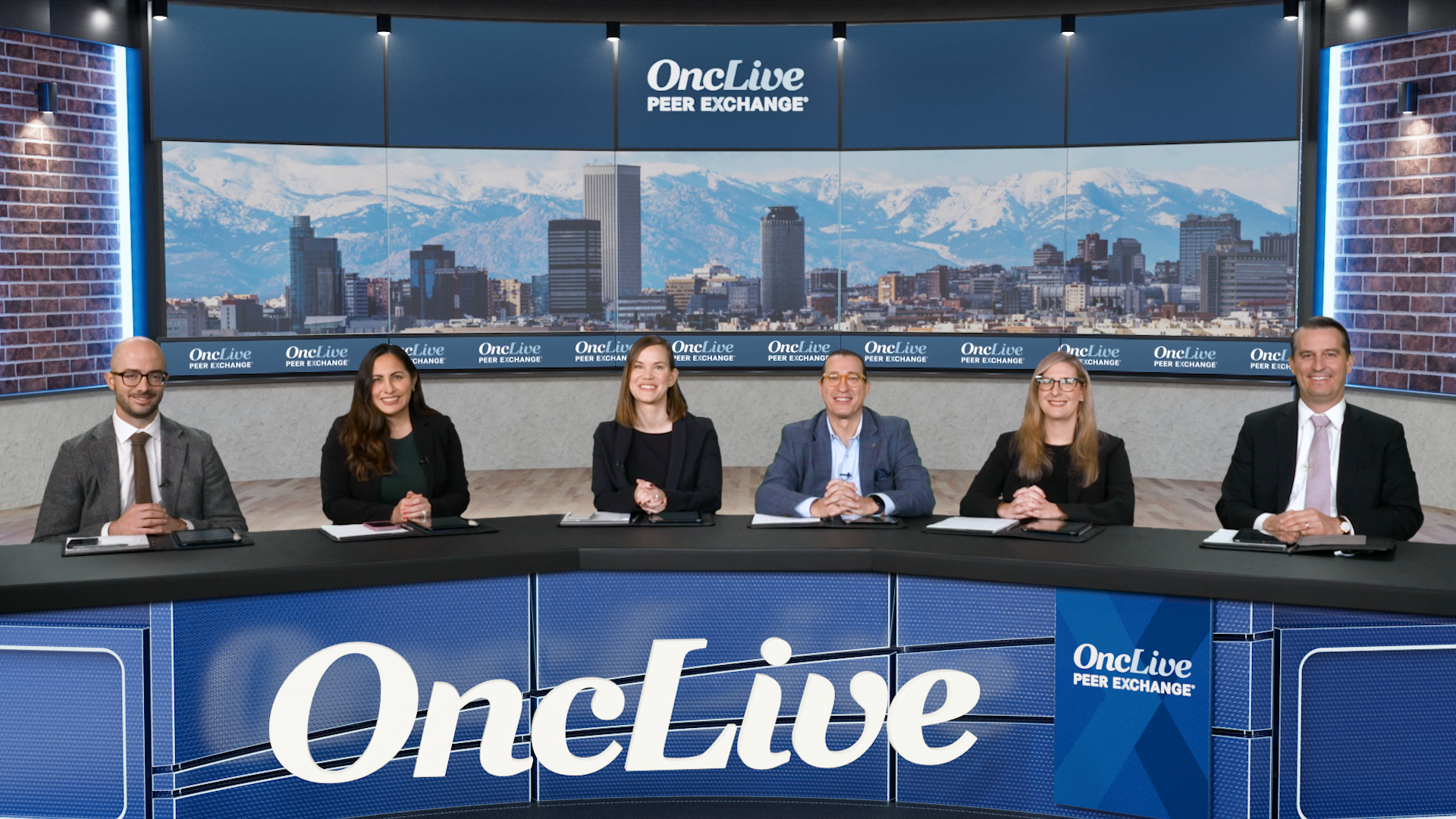 A panel of 6 experts on chronic lymphocytic leukemia seated at a long desk