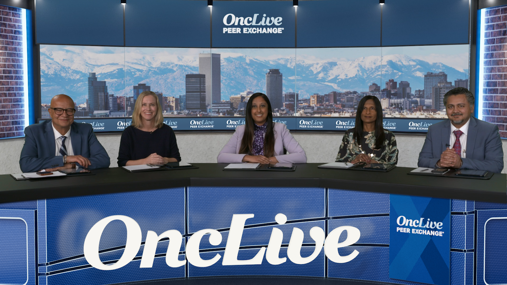 A panel of 5 experts on multiple myeloma seated at a long table