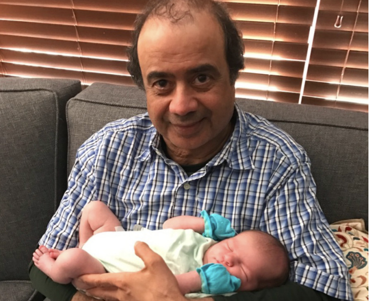 Ajani with his then 4-month-old granddaughter, Maya.